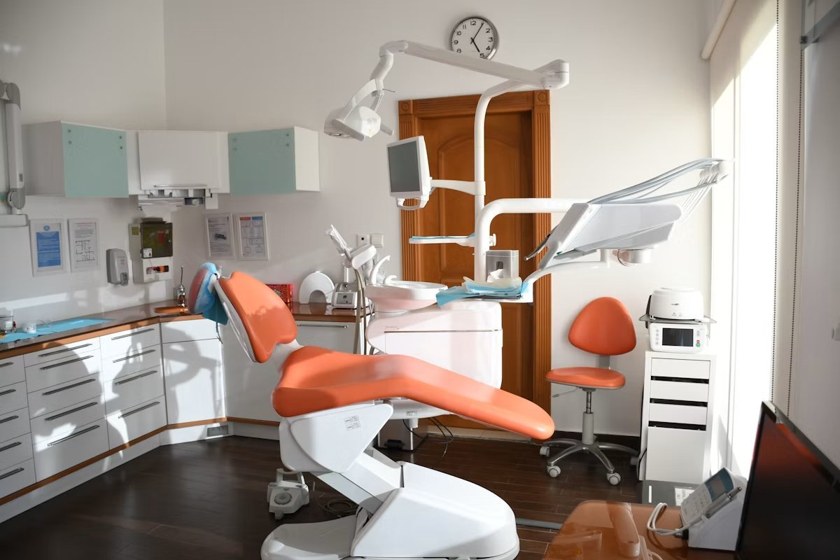 Modern dental treatment room with a dental chair and equipment